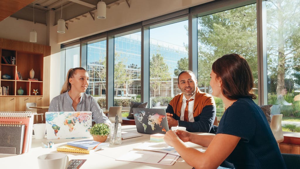 Three service business employees discussing edmonton web design services that will help them get more customers