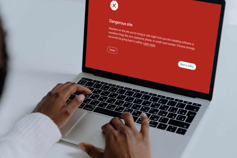 User looking at Google Chrome red warning screen for unsafe website – represents risks of cheap hosting for Edmonton businesses